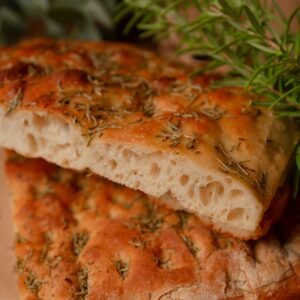 Delicious homemade focaccia bread with rosemary, perfect for gourmet meals or snacks.