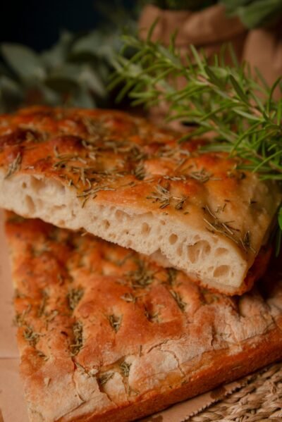 Delicious homemade focaccia bread with rosemary, perfect for gourmet meals or snacks.